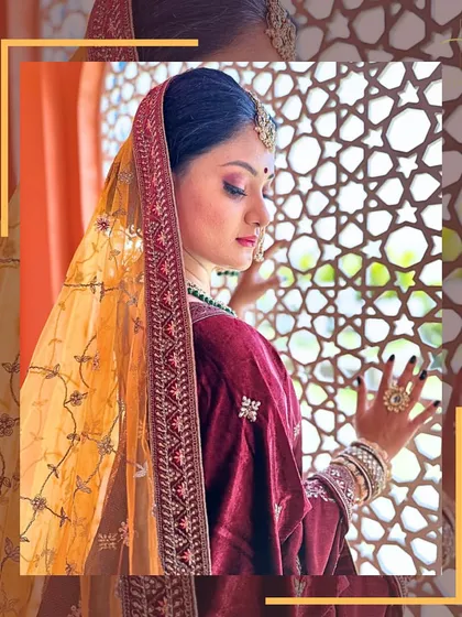 A side profile showcasing the beautiful drape of the dupatta and the intricate work on the velvet blouse of this bridal lehenga.