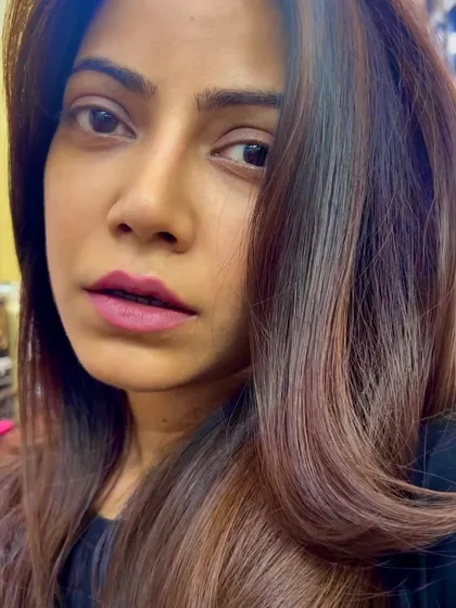 A close-up of a gorgeous caramel balayage. The "mini-kiss" technique adds just the right amount of light for a sun-kissed glow.