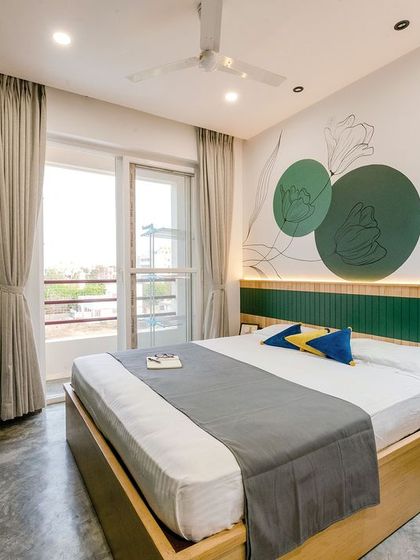 Another angle of the T7 T8 master bedroom, highlighting the natural light from the balcony and the simple, elegant lines of the custom bed frame.