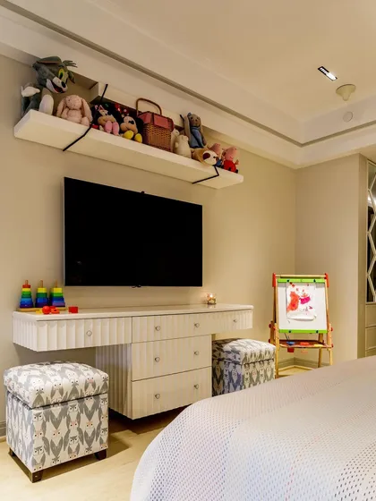 A functional and fun corner in a child's room. The floating console serves as a vanity or art desk, with a high shelf above for storing stuffed animals and treasures.