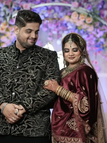 A candid moment of connection between the couple, capturing a gentle touch and soft smiles.