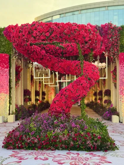 Another angle of the dramatic red floral sculpture, showing how it commands attention and creates a central point of interest in the large outdoor space.