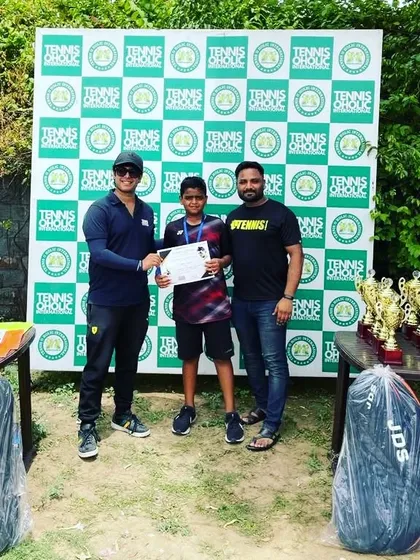Standing with my trainee Gyan after he secured 3rd position at an All India Tennis Tournament. This photo was taken at the awards ceremony, recognizing his hard-fought matches.