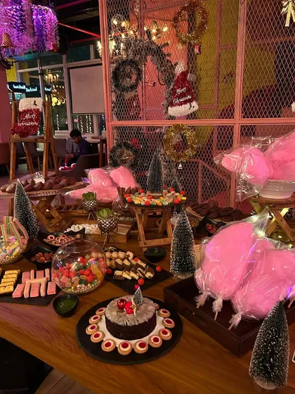 A spectacular candy land grazing table for a kid's Christmas-themed birthday party. This was an absolute showstopper, filled with chocolates, candies, cotton candy, and cakes.