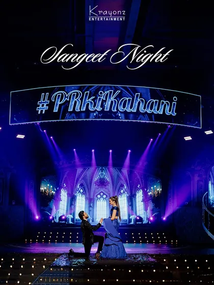 Your Sangeet night deserves a stage that matches its energy. We designed this dramatic, cathedral-inspired backdrop with dynamic lighting to create a truly cinematic experience for the couple's grand performance.