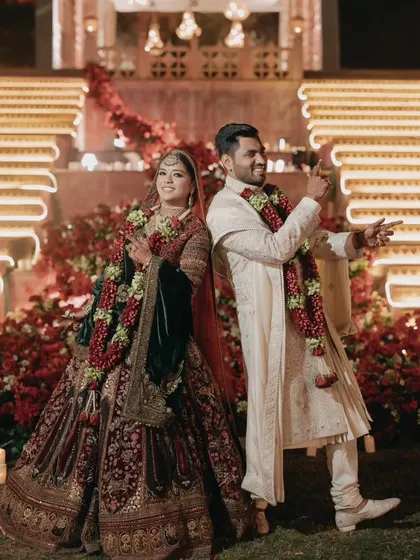 After the ceremony, the happy couple strikes a playful pose. We ensure that amidst all the grandeur and tradition, there is always space for the couple's personality and joy to shine through.