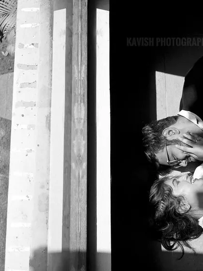 An artistic black and white pre-wedding photo using shadows and high contrast to create a dramatic and intimate scene.
