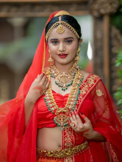 A close-up of the North Indian bridal makeup, featuring a bold red lip and defined eyes.
