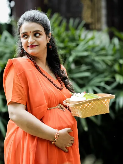 A beautiful three-quarter portrait of the expectant mother from our Ram and Seetha shoot. She holds a basket of flowers, adding a classic, graceful element to her character.