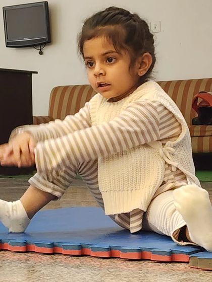 A young student works on her seated stretches. We incorporate foundational movements that build strength and flexibility for their dance journey.