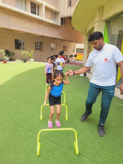 Agility drills are a core part of our fitness program. An instructor guides a camper through a set of mini hurdles, an exercise designed to improve footwork, speed, and coordination.