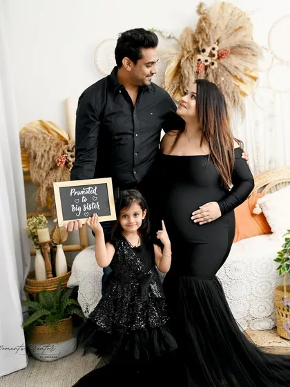 "Promoted to Big Sister!" This family portrait is a fun and heartwarming way to announce the new arrival, with the whole family dressed in coordinating black outfits in my boho-themed setup.
