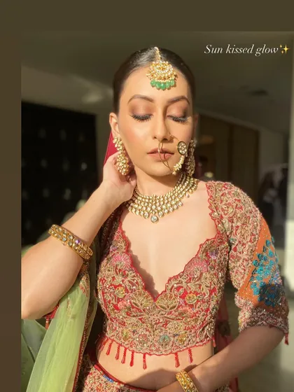 A beautiful profile shot highlighting the delicate details of the makeup and jewelry. The soft contouring and shimmering highlighter catch the light perfectly, adding dimension and a touch of magic.