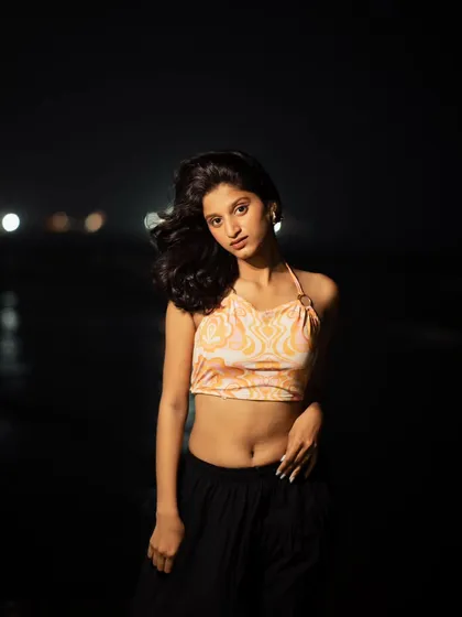 A classic portrait pose, beautifully lit against the dark beach. This type of shot is timeless and great for any portfolio.