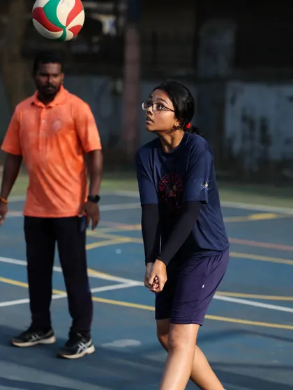 A U-14 player focuses intently as she prepares to pass the ball. Her form shows the quality of instruction she is receiving.
