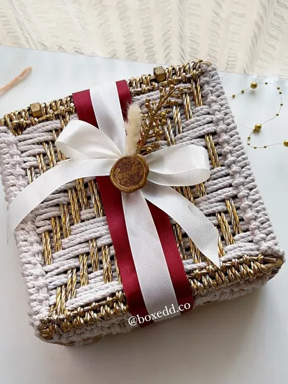 We design wedding invitations that set the tone for your entire celebration. This handcrafted woven box, finished with a custom wax seal, moves beyond a simple card to become a beautiful keepsake and the first taste of your wedding's aesthetic.