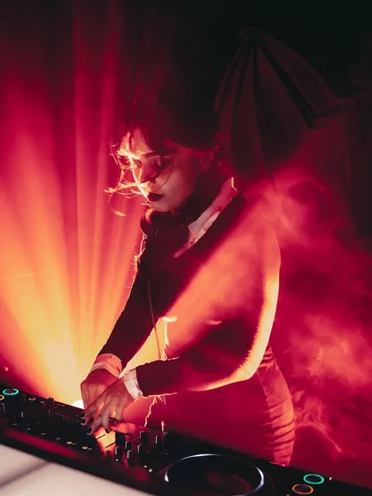 Channeling my inner Wednesday Addams for a Halloween gig. I love bringing a theme to life, whether it's for a holiday, a brand event, or a private party. This is me at the decks, setting a dark disco vibe with a spooky twist.