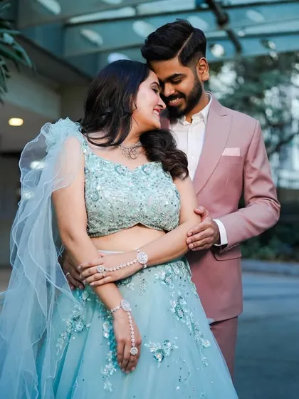 A sweet and tender moment from a pre-wedding or engagement shoot. The soft colors and natural light create a romantic mood.