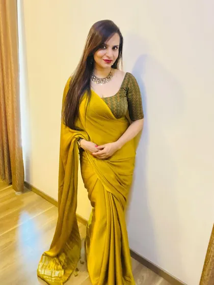 Here I am in one of my own designs for Diwali. This is a simple yet elegant mustard yellow saree with a subtle sheen, paired with a custom-stitched chevron print blouse for a contemporary festive look.