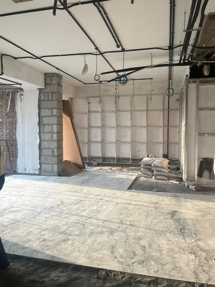 Another view from The Corridors site in Gurugram, showing the exposed ceiling pipes and blockwork. This raw, industrial stage is a critical part of the construction process before the finishing layers are applied to create a seamless and luxurious flow.