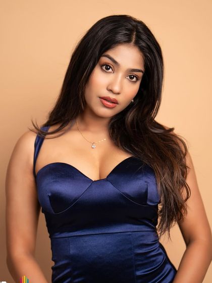 A duplicate of 14, this studio portrait of Pooja Ramesh in a striking blue satin dress makes the color and texture of the dress stand out.