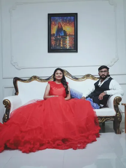 A regal portrait for the happy couple. This vibrant red ball gown fills the frame beautifully, creating a luxurious feel for this indoor pre-wedding photo.
