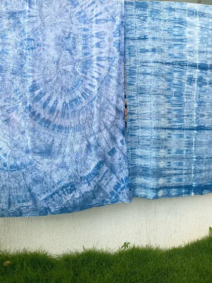 A beautiful display of fabrics hand-dyed with natural indigo. The different shades and patterns show the versatility and depth of this magical blue dye.