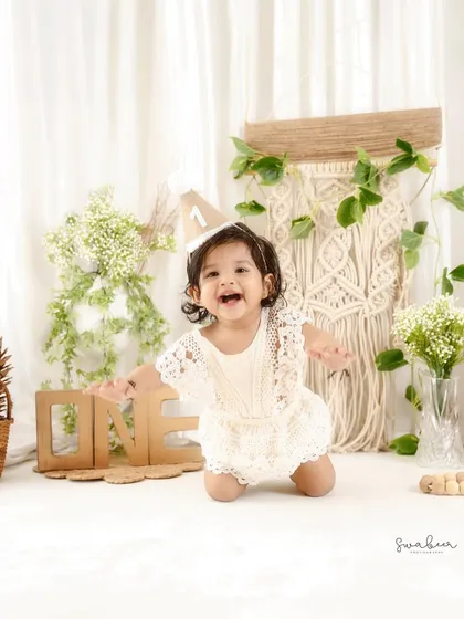 A huge, excited smile. This boho-themed first birthday shoot captures the pure joy of being one year old.