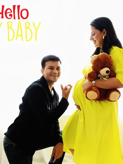 "Hello My Baby!" A playful and excited dad-to-be talks to the bump in this fun and lighthearted announcement photo.