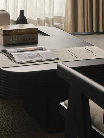 This custom black coffee table with fluted details serves as a bold centerpiece in the living room. Paired with a classic Chandigarh chair, it reflects my approach of mixing modern forms with timeless design elements.