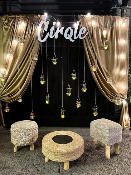 We can transform any space for a modern festive party. For this Diwali celebration, we created a chic photo booth with golden drapes, hanging candle-lit jars, and rustic jute seating, perfect for capturing stylish memories.
