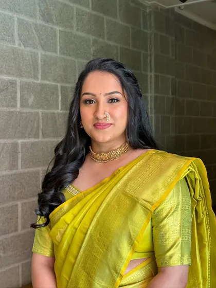 The client looking lovely in her yellow saree. The half-up style is a great way to wear your hair down while still feeling put-together.