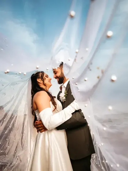 A dreamy and intimate portrait under the bride's veil. This creative shot creates a private little world for the couple, filled with smiles and soft light.