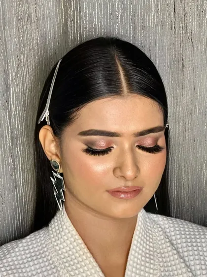 In the making of this party look. The client is in a robe while I create a soft pink smokey eye, showing the prep work before she gets into her final outfit.