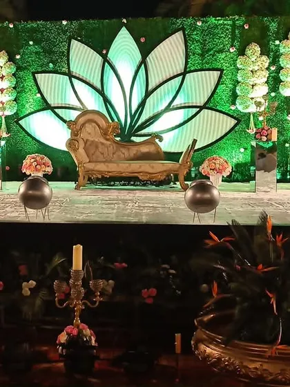 A unique stage design with a large, illuminated lotus motif and a vintage-style chaise lounge, creating a dramatic and artistic focal point.