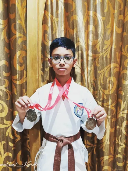 Believing in yourself is the first step to success. This brown belt student proudly displays the medals he earned through his dedication and strong belief in his abilities.