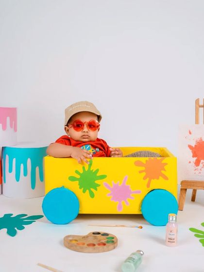 This little artist is too cool for school. Adding fun sunglasses gives this painter-themed setup a playful and modern twist, showing off the baby's personality.