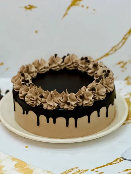 My all-year-round Mousse Cake is light, airy, and incredibly smooth. This one features a chocolate mousse with a glossy drip and piped frosting, making it an elegant and delicious dessert for any time of year.