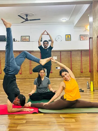 Our community is the heart of our studio. We create intricate group poses like this one not just for the physical challenge, but to build connection, trust, and share a few laughs along the way.