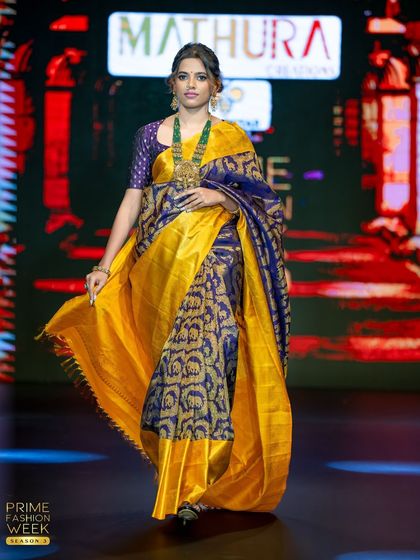 The movement of the yellow pallu adds a dynamic element to this beautiful runway look.