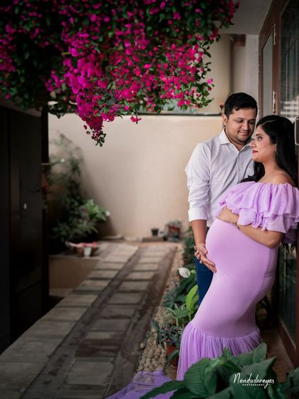 This candid shot captures the couple in a private garden setting, a perfect example of an intimate at-home maternity session.