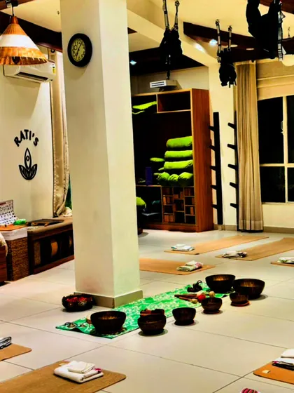 The studio prepared for a sound healing session. Each mat is a personal sanctuary, with singing bowls placed centrally to create a field of high-vibrational energy that envelops the entire room.