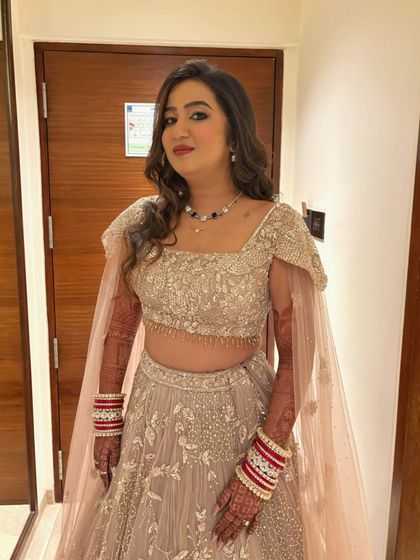 The final look in a series of five for one bride: her reception. She radiates elegance and grace in a beautiful pastel lehenga with soft, glowing makeup.