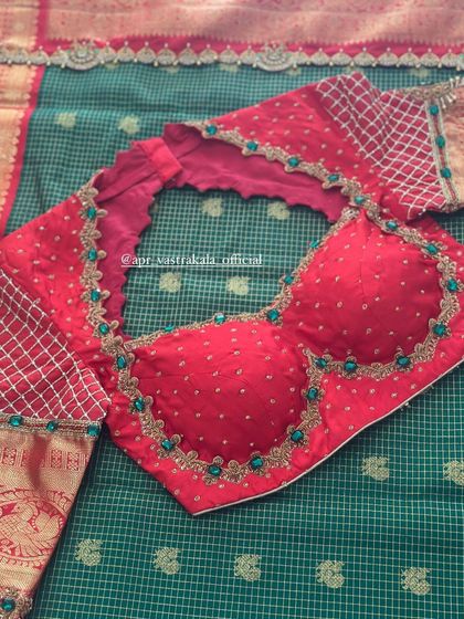 The front of the red blouse, with a checkered pattern on the sleeves.