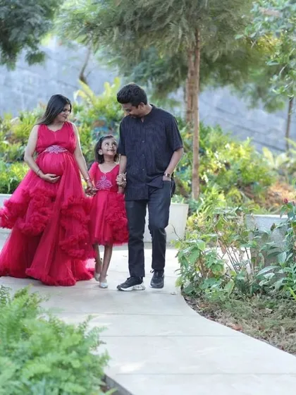 We coordinate outfits for the entire family so you look and feel like a team. This matching pink ruffle set for mom and daughter, coordinated with dad's outfit, is perfect for family portraits and events.