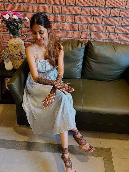 A beautiful portrait of a bride-to-be, relaxed and happy after her mehndi session.