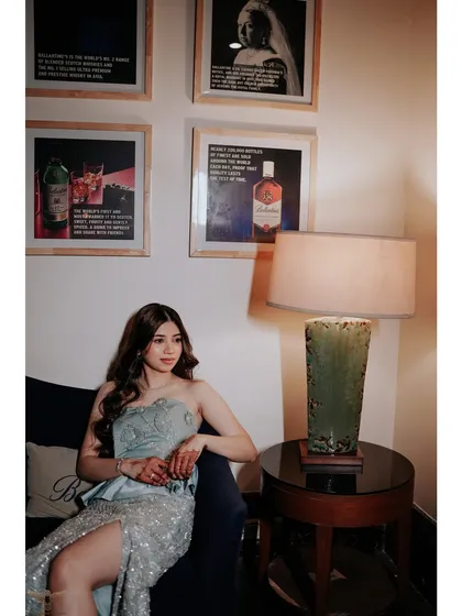 Another beautiful portrait of the bride-to-be, capturing a moment of quiet elegance amidst the party atmosphere. The soft lighting and thoughtful expression create a stunning image.