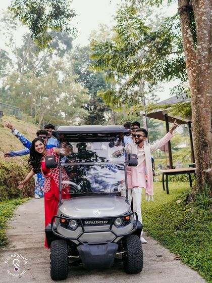 The wedding party having fun with a golf cart at a resort-style Haldi event.