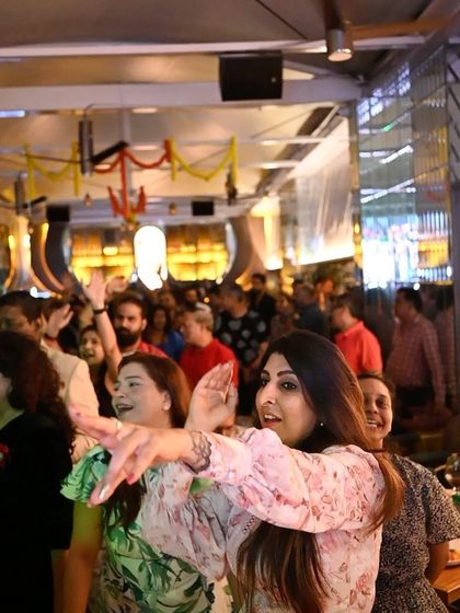 The crowd at Badmaash UB City, fully engaged and dancing to the beat.