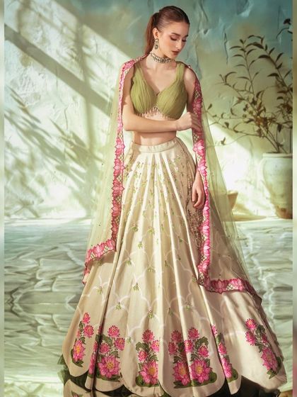 The elegance of this floral lehenga is complemented by the soft, dappled light of the projected background. The entire look feels fresh, modern, and perfect for a daytime celebration.
